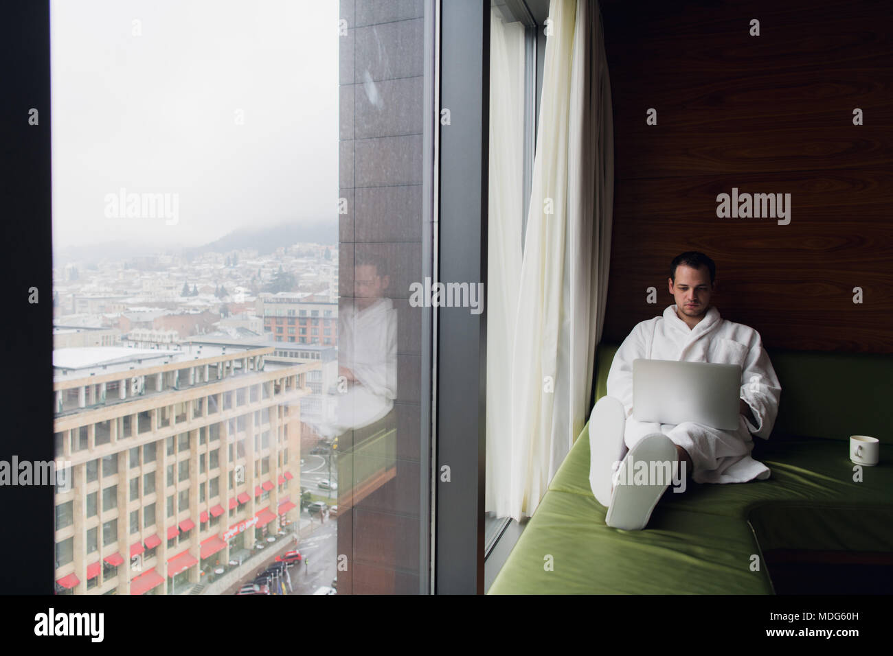 Young man freelancer working from home on a laptop Stock Photo