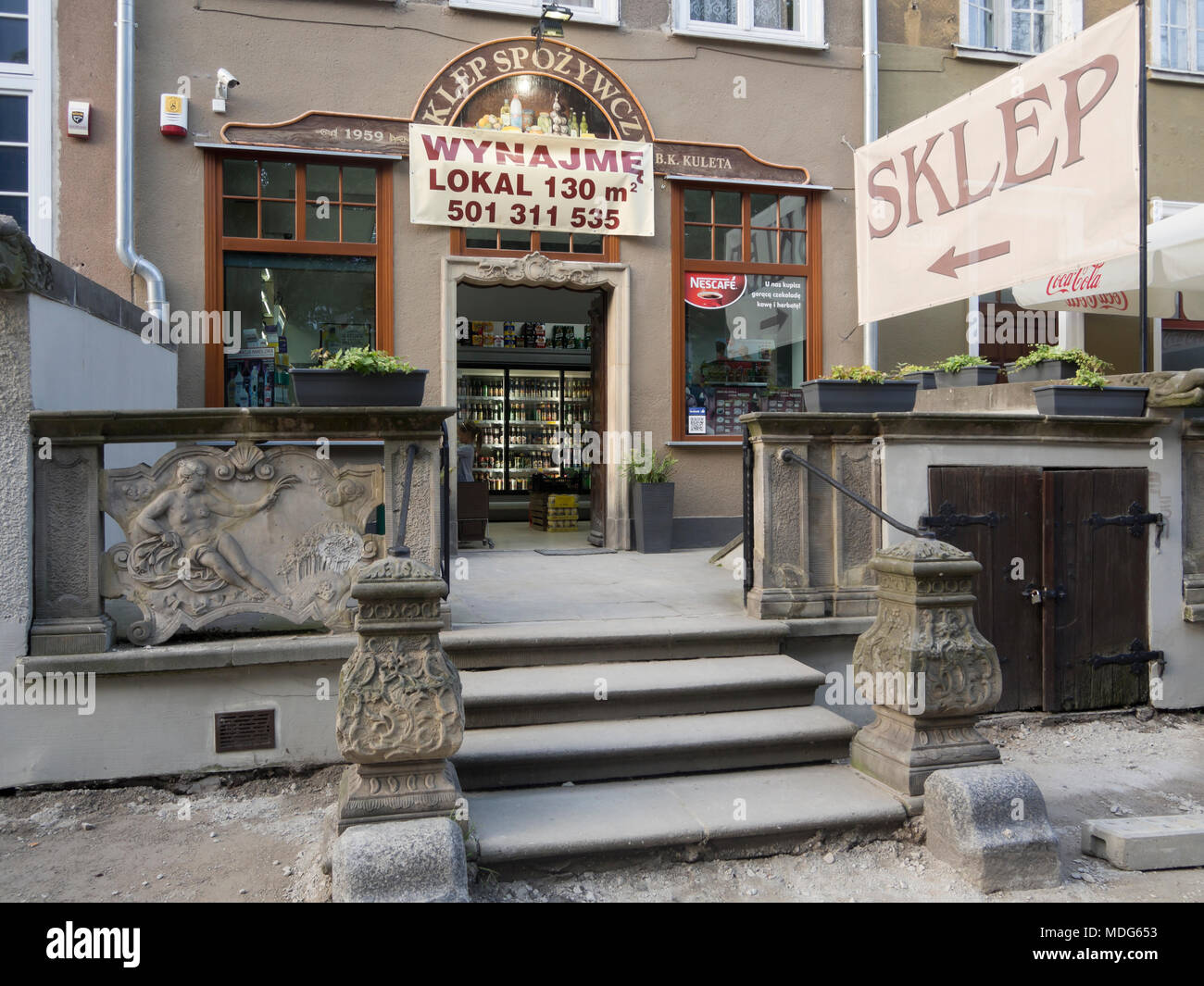 Sklep, shop, groceries for sale and space to rent in this building in the Main Town in Gdansk Poland Stock Photo