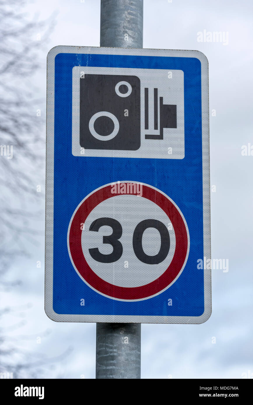 30 mph speed limit road sign with camera warning. Stock Photo