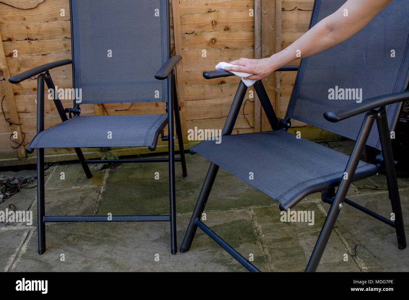 Cleaning garden furniture Stock Photo Alamy