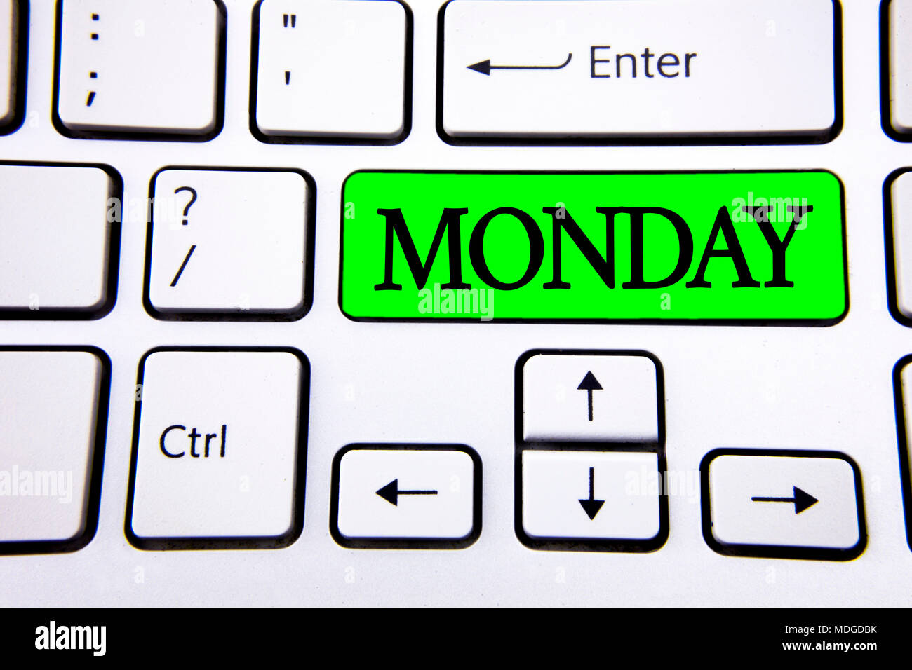 Word writing text Monday. Business concept for First day of the week Back to work Weekend is over Wakeup Early written Green Key Button White Keyboard Stock Photo