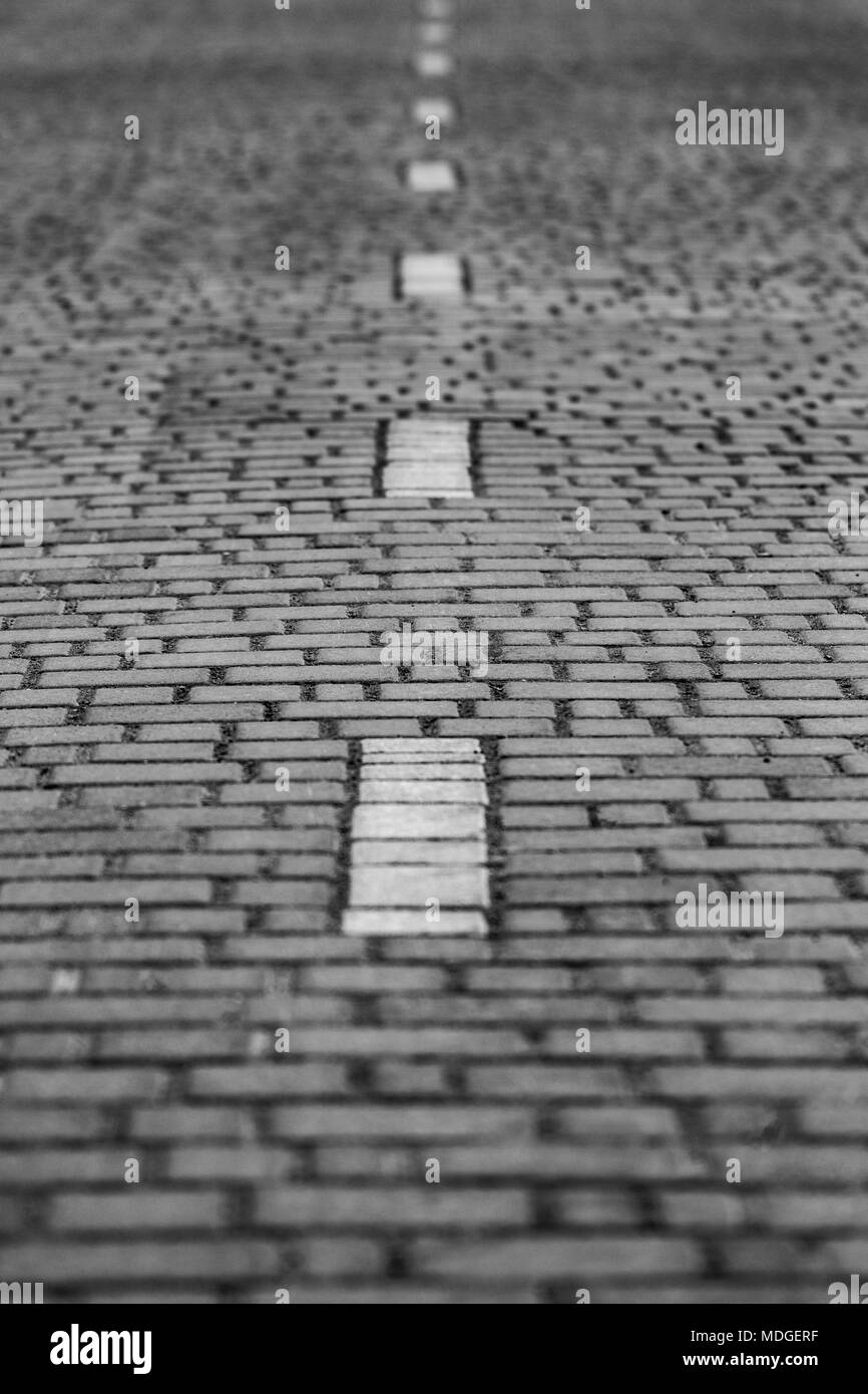 Interlocking paving with gray and white concrete blocks; Concrete products; Construction industry. Stock Photo