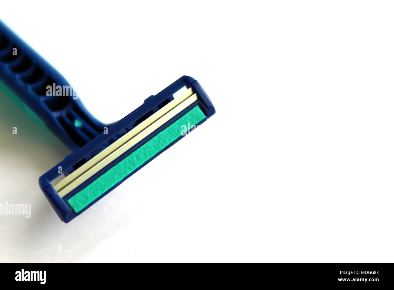 Detail of metal blades and emollient gel strip on a male razor isolated