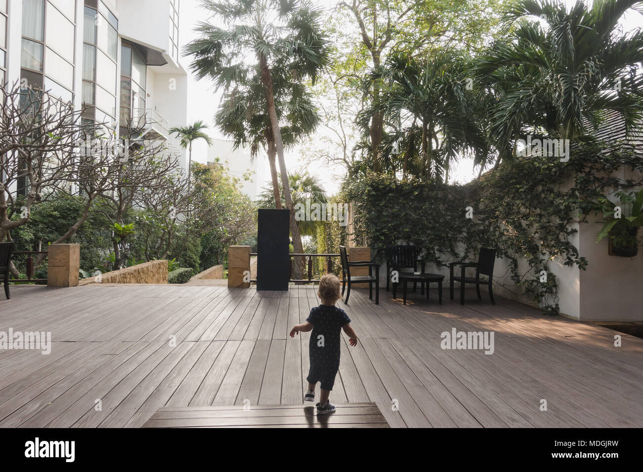 Little boy running on hotel terrace Stock Photo