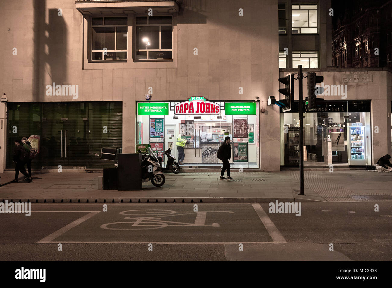 Papa Johns pizza takeaway on Oxford Street in the centre of Manchester on a cold winter night Stock Photo