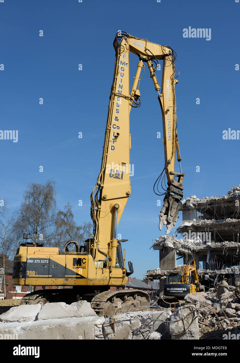 Caterpillar 350L high reach demolition excavator with concrete crusher  attachment and partly demolished concrete building on demolition site, bury  uk Stock Photo - Alamy