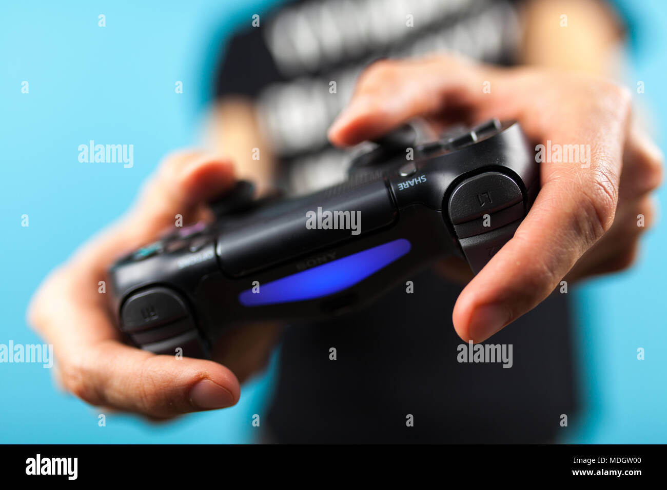 Male hands holding a Playstation 4 Dualshock controller Stock Photo Alamy