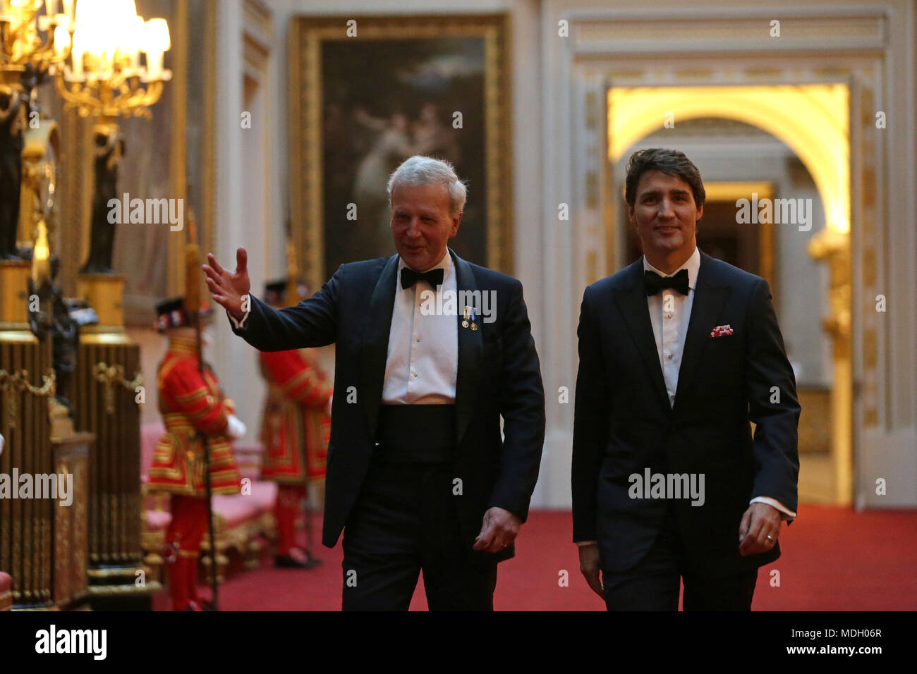 Canada's Prime Minister Justin Trudeau (right) arrives in the East Gallery at Buckingham Palace in London as Queen Elizabeth II hosts a dinner during the Commonwealth Heads of Government Meeting. Stock Photo