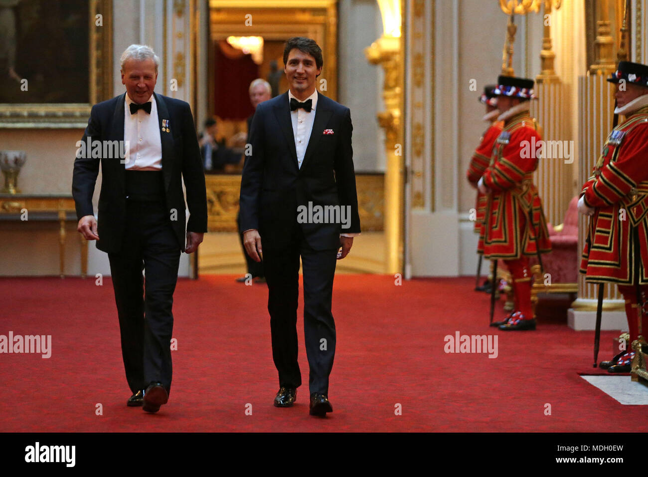 Canada's Prime Minister Justin Trudeau (right) arrives in the East Gallery at Buckingham Palace in London as Queen Elizabeth II hosts a dinner during the Commonwealth Heads of Government Meeting. Stock Photo
