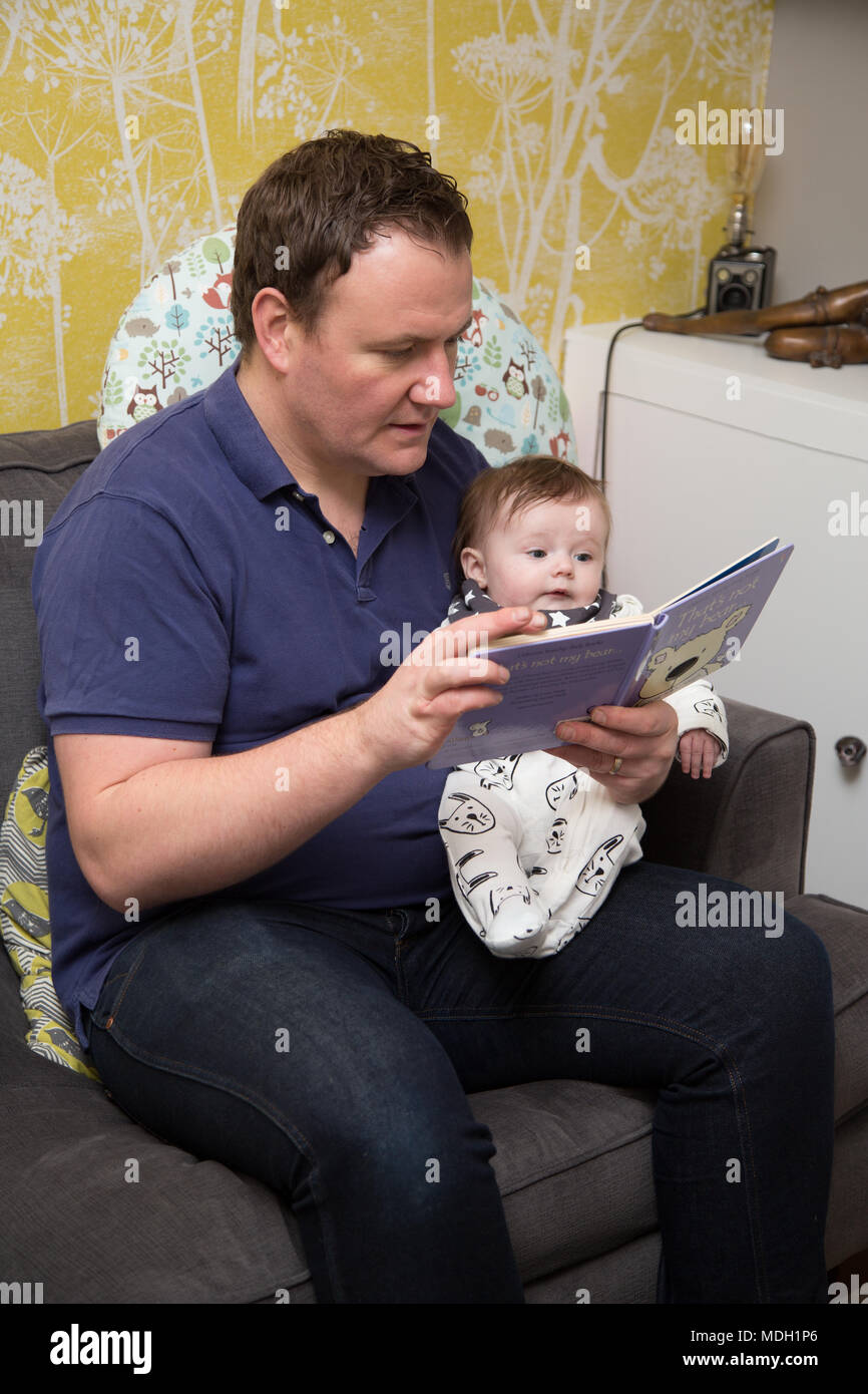 Father reading to baby Stock Photo