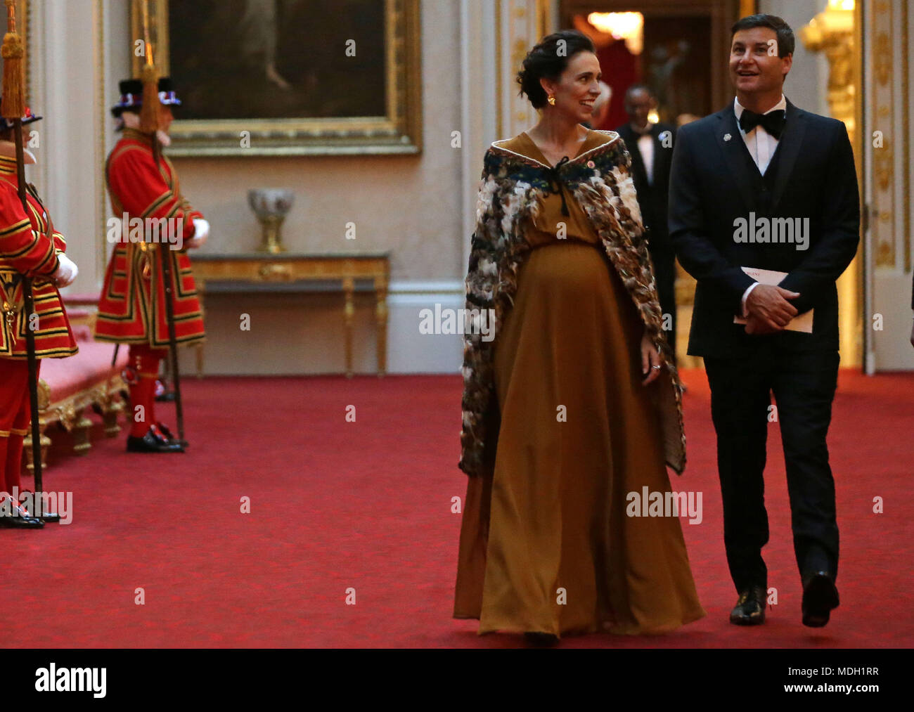 New Zealand's Prime Minister Jacinda Ardern and her partner Clarke Gayford arrive in the East Gallery at Buckingham Palace in London as Queen Elizabeth II hosts a dinner during the Commonwealth Heads of Government Meeting. Stock Photo