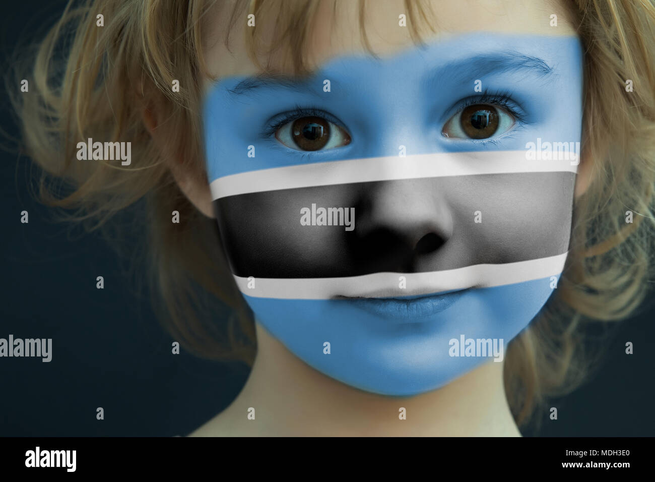 Child with a painted flag of Botswana Stock Photo - Alamy