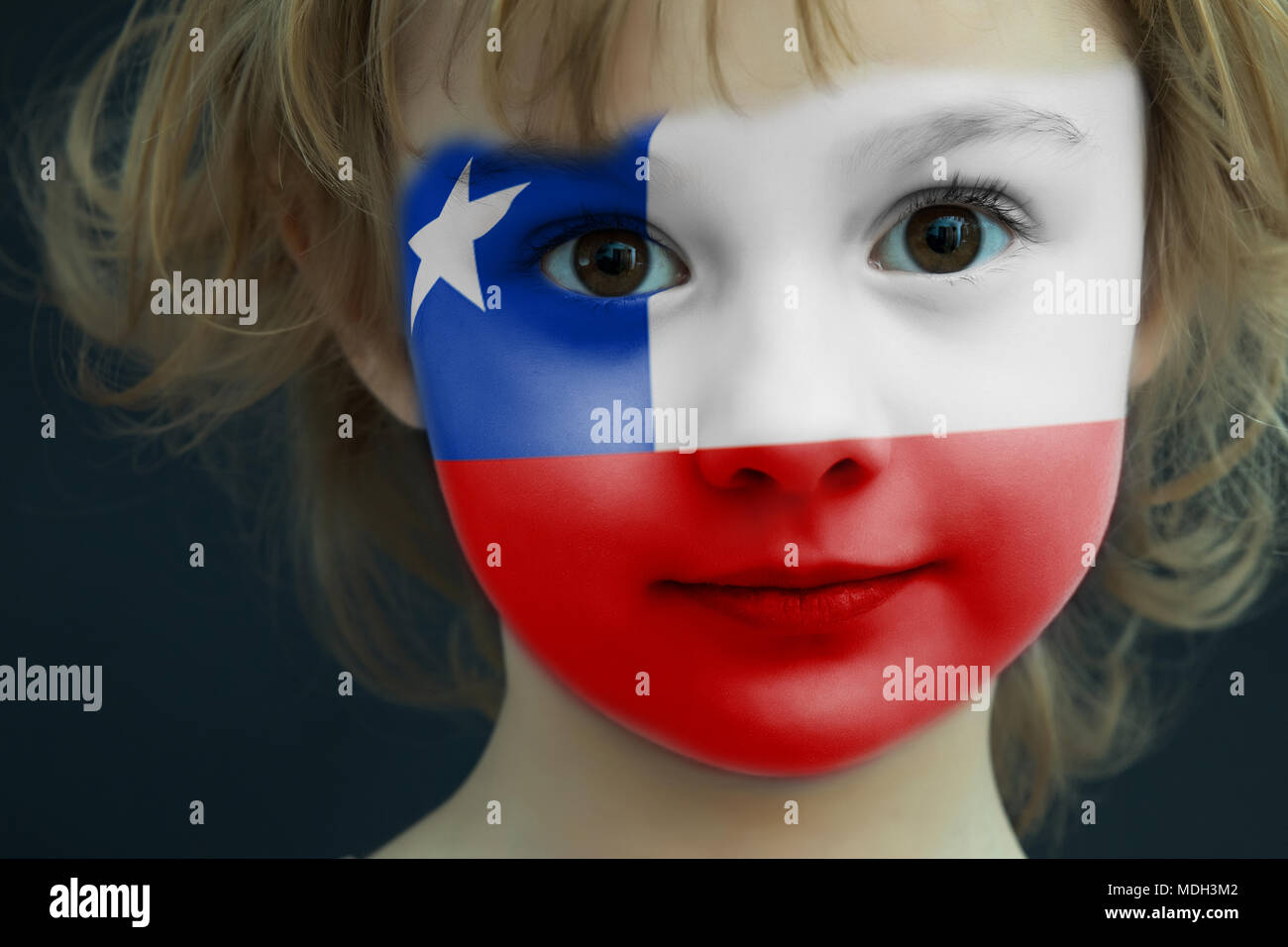 Child with a painted flag of Chile Stock Photo