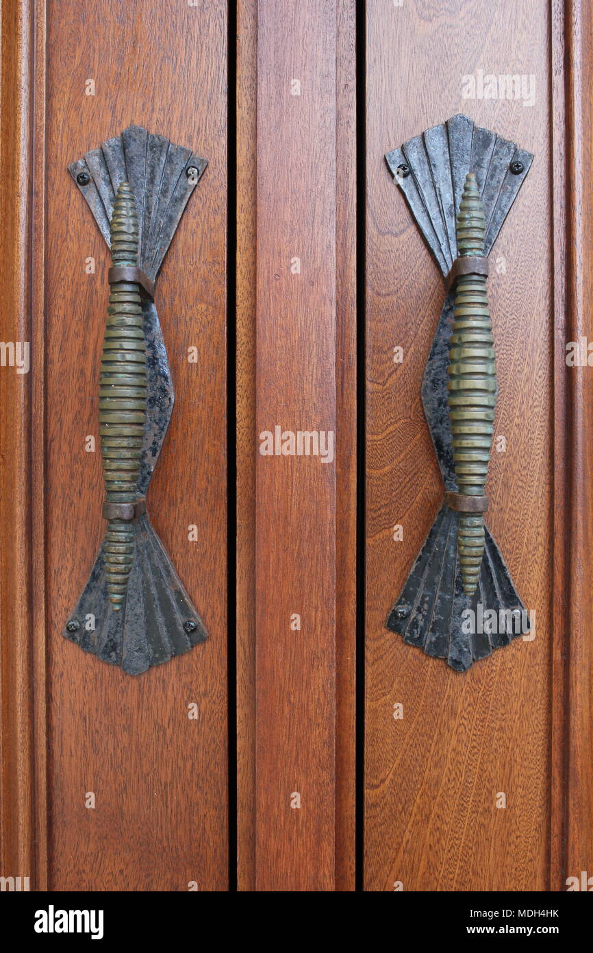 Twin decorative door handles on a beautiful wooden door Stock Photo Alamy