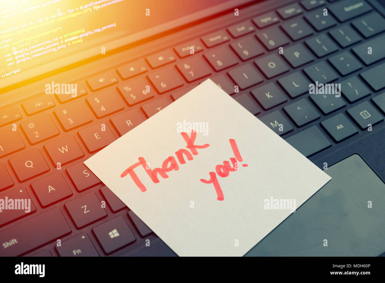 Thank you message concept written post it on laptop keyboard Stock Photo