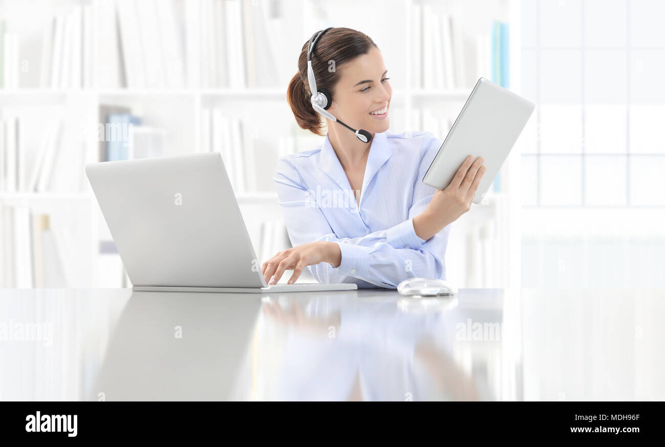 Business smiling woman or a clerk working at her office desk with