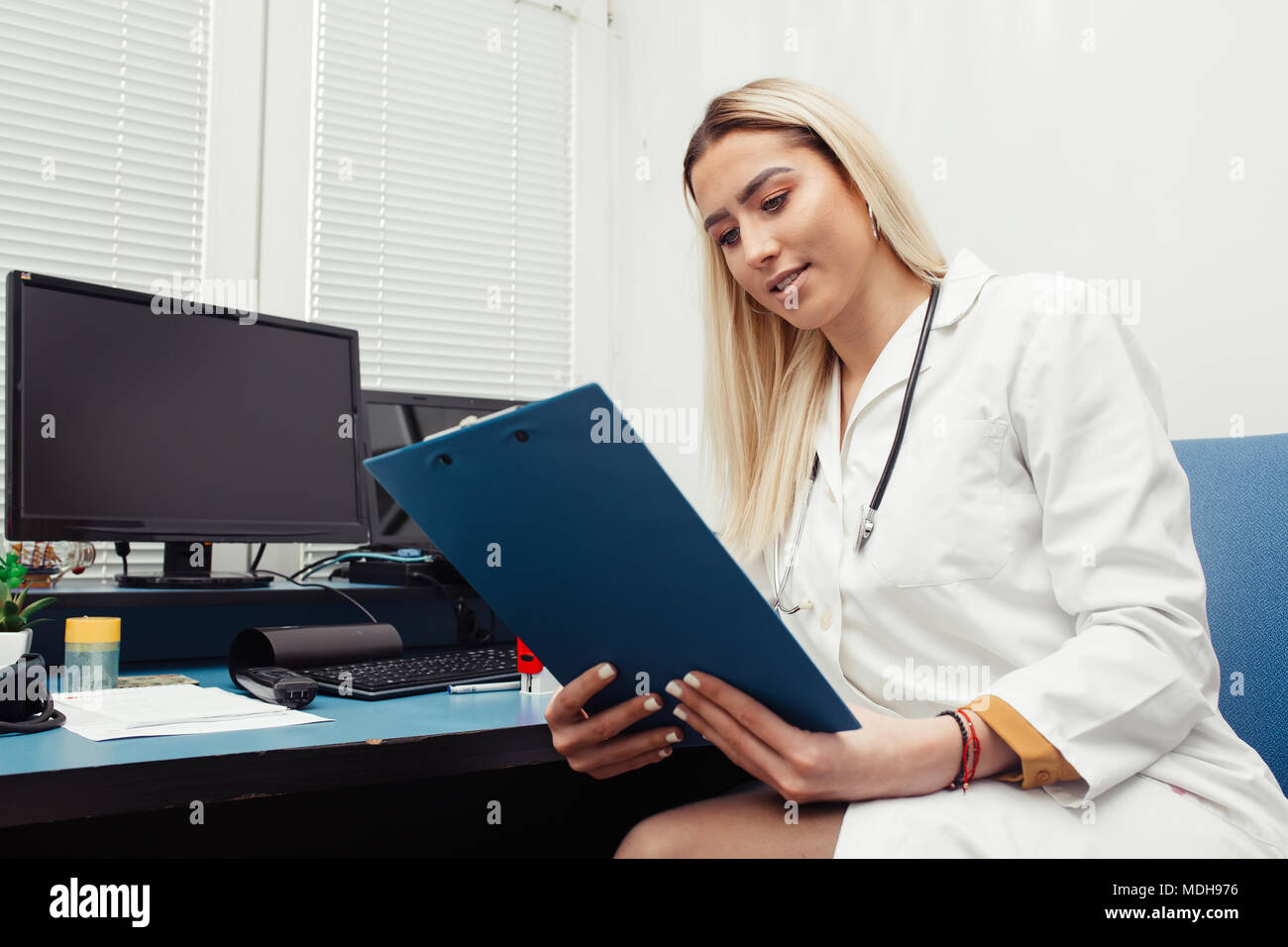 Doctor in the office checking paperwork and patient's medical records.Healthcare and medicine