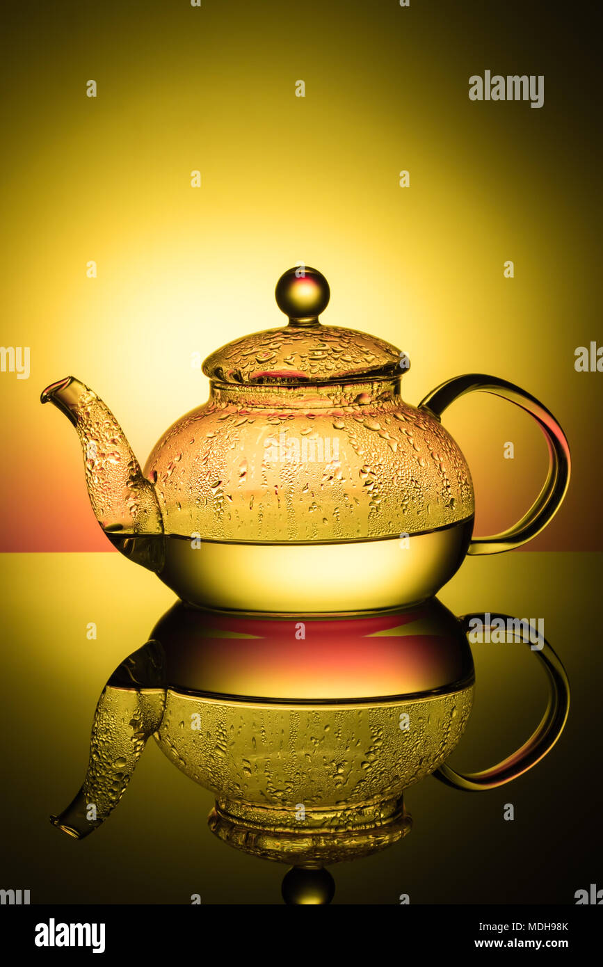 Glass teapot with boiling water and drops of condensation Stock Photo