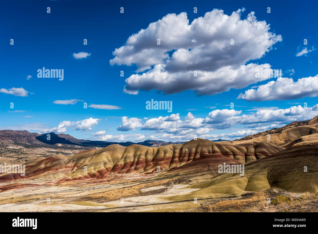 Clouds float above the Painted Hills Unit of John Day Fossil Beds National Monument; Mitchell, Oregon, United States of America Stock Photo