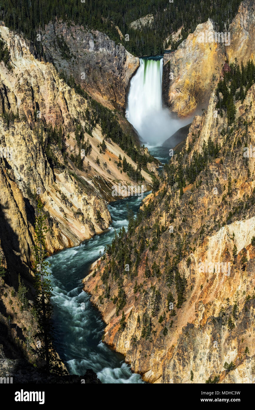 Waterfall and river on rugged terrain, Yellowstone National Park, Wyoming, United States of America Stock Photo