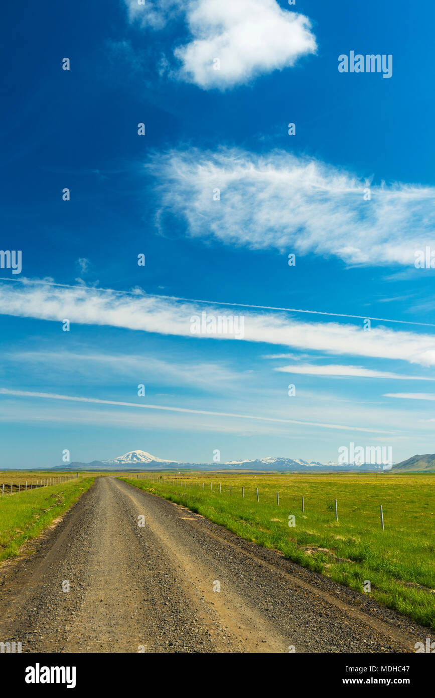 Looking down gravel road to Hekla volcano in the distance; Iceland Stock Photo