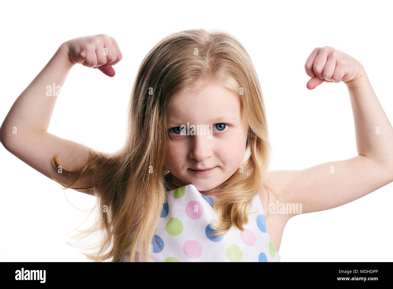 A young girl with blond hair shows her muscles on a white background Stock Photo