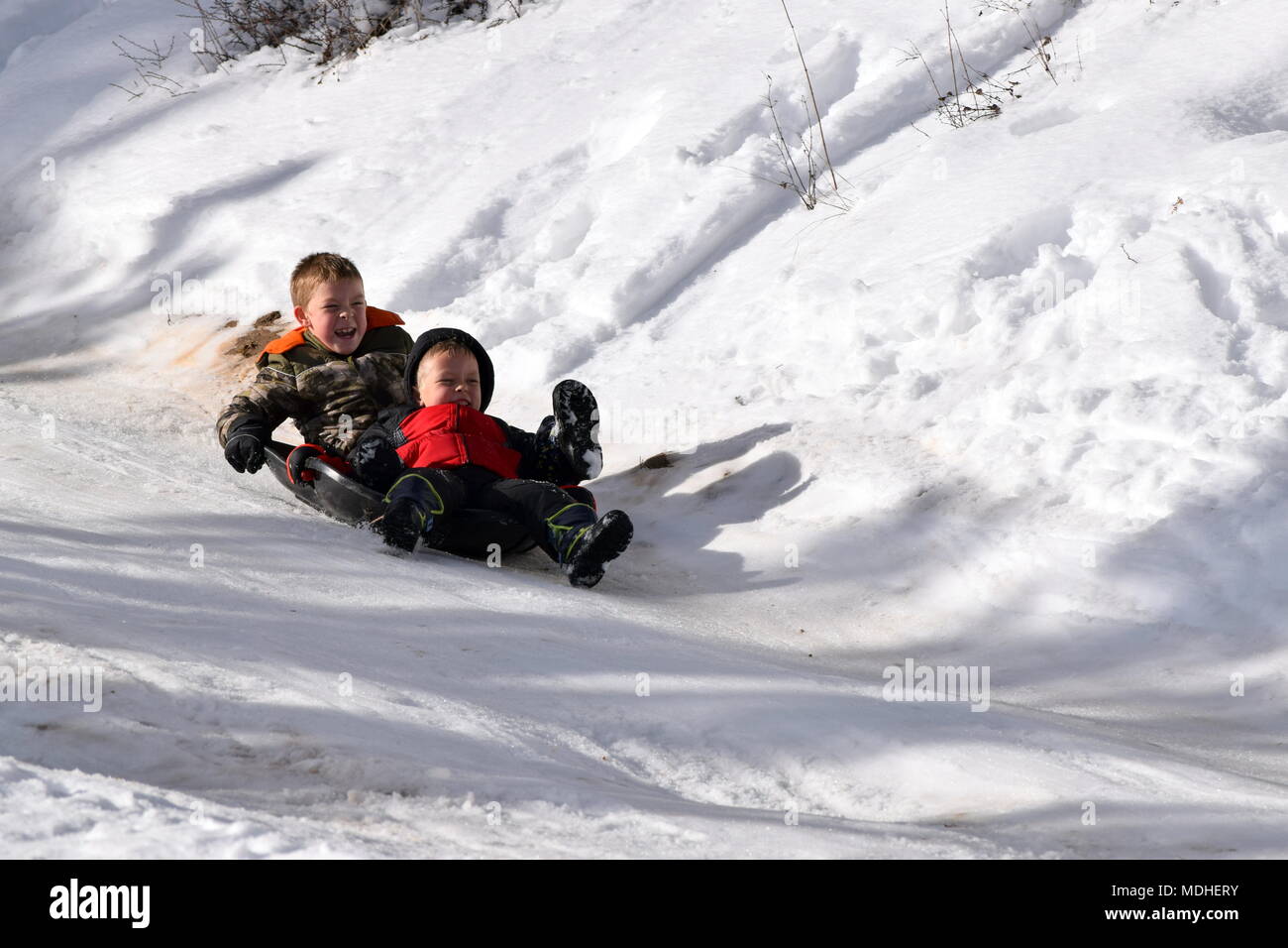 children sledding Steamboat Gulch, Idaho Stock Photo