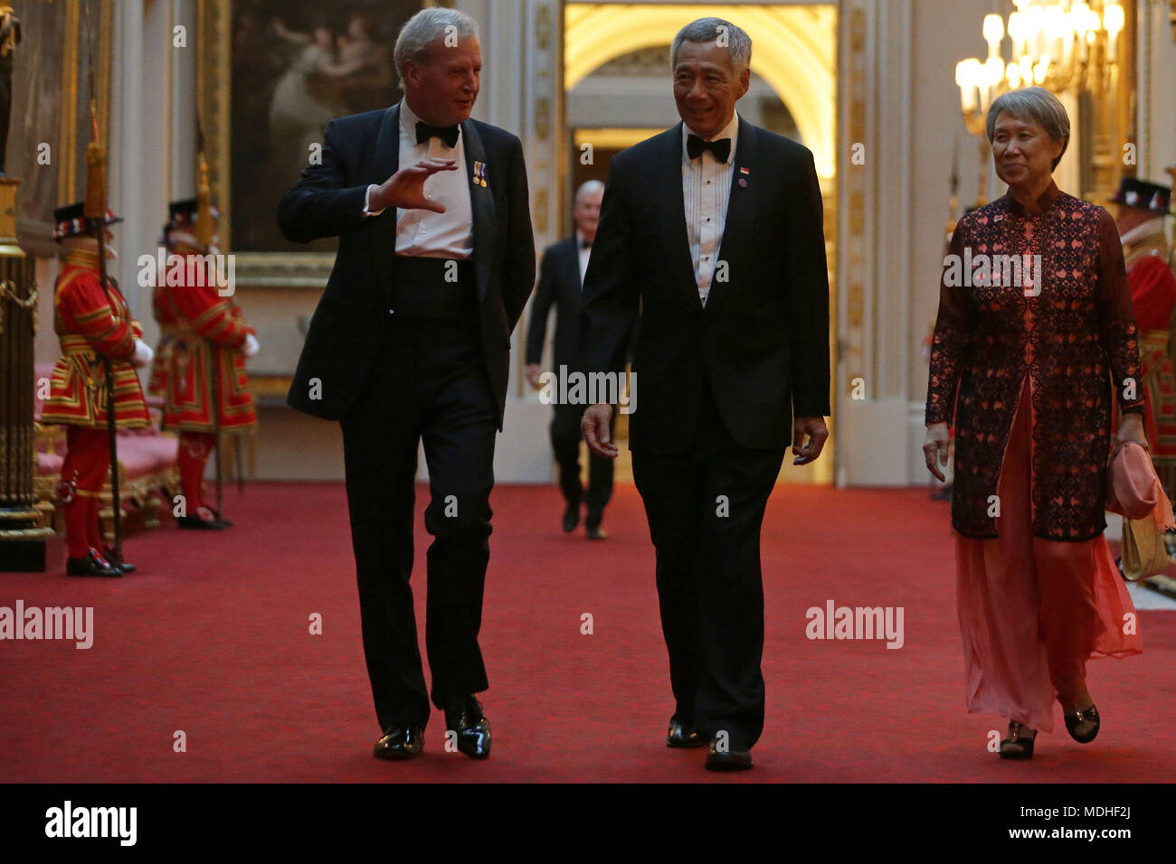 Singapore's Prime Minister Lee Hsien Loong (centre) and his wife Ho Ching arrive in the East Gallery at Buckingham Palace in London as Queen Elizabeth II hosts a dinner during the Commonwealth Heads of Government Meeting. Stock Photo