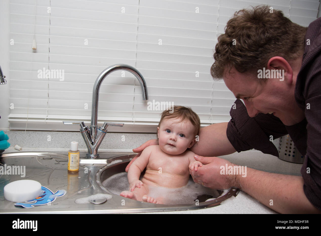 Dad Washing Baby In Kitchen Sink Stock Photo 180479259 Alamy