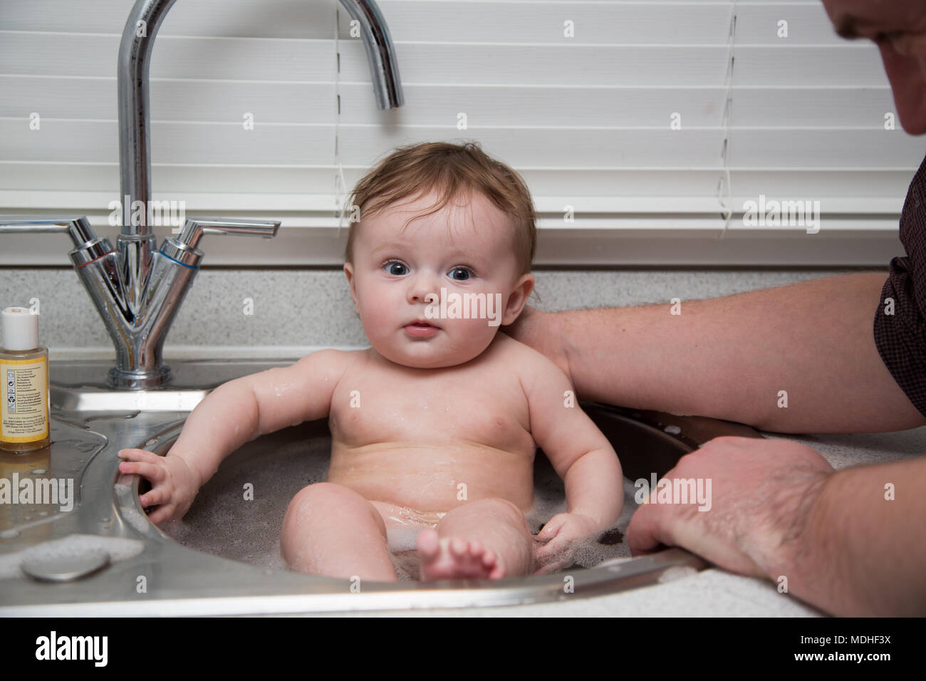 Dad Washing Baby In Kitchen Sink Stock Photo 180479262 Alamy