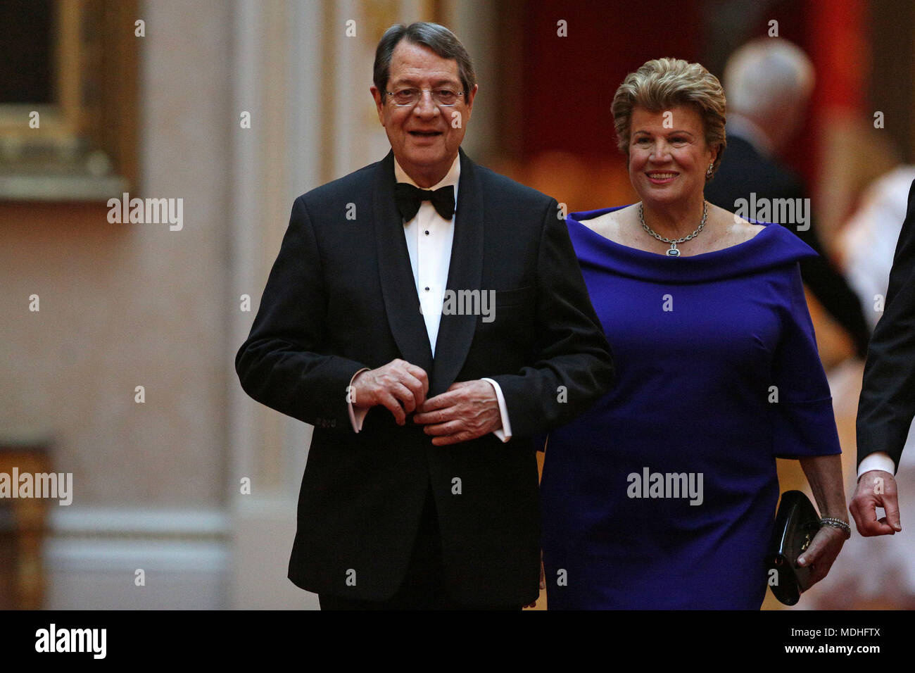 Cyprus President Nicos Anastasiades and his wife Andri arrive in the East Gallery at Buckingham Palace in London as Queen Elizabeth II hosts a dinner during the Commonwealth Heads of Government Meeting. Stock Photo