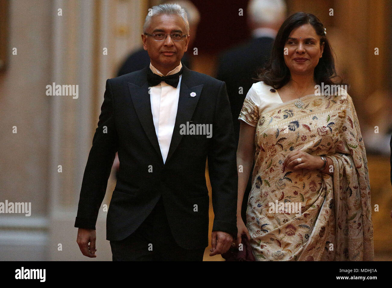 Mauritius Prime Minister Pravind Jugnauth and his wife Kobita Ramdanee arrive in the East Gallery at Buckingham Palace in London as Queen Elizabeth II hosts a dinner during the Commonwealth Heads of Government Meeting. Stock Photo