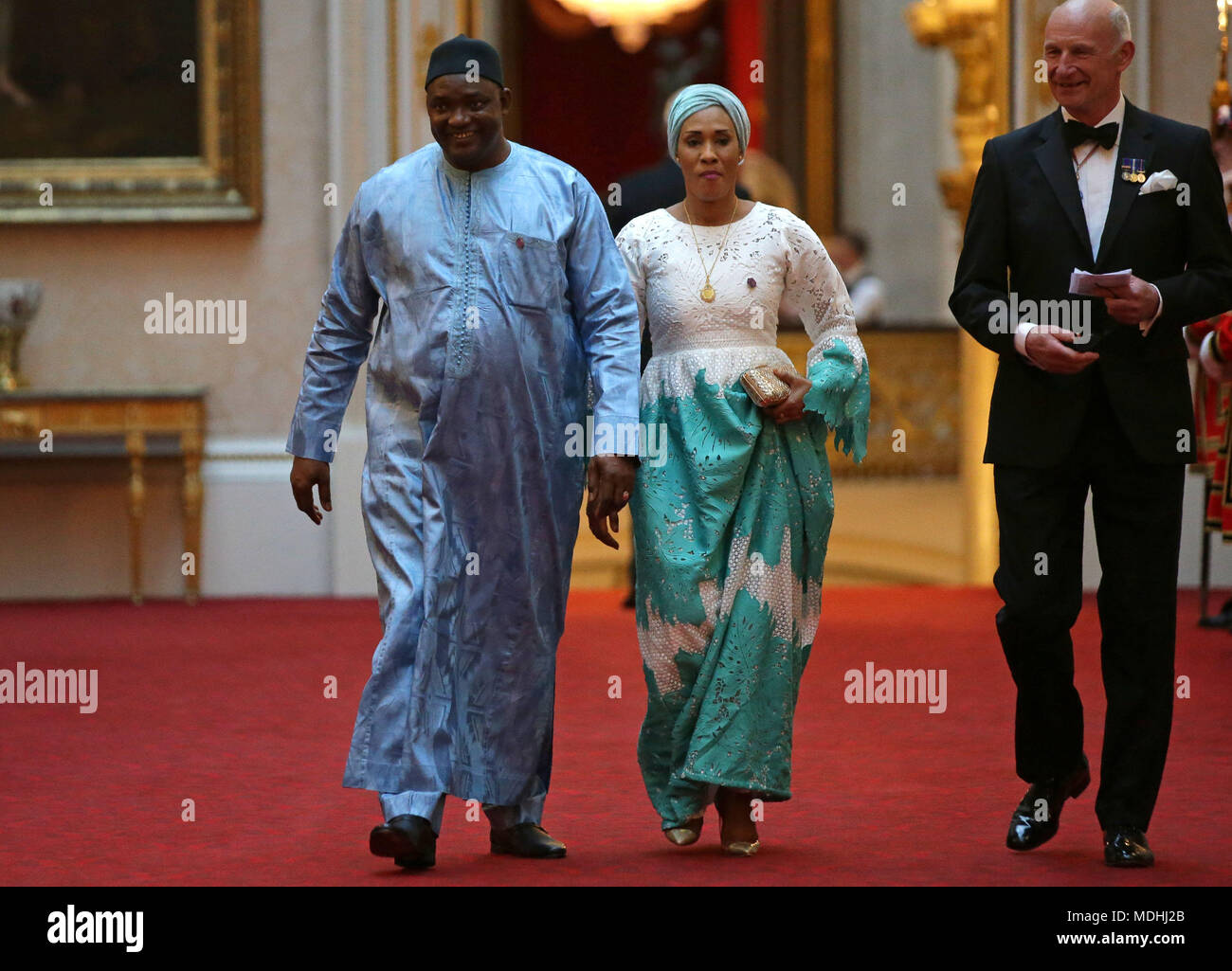 The Gambia's President Adama Barrow (left) arrives in the East Gallery at Buckingham Palace in London as Queen Elizabeth II hosts a dinner during the Commonwealth Heads of Government Meeting. Stock Photo