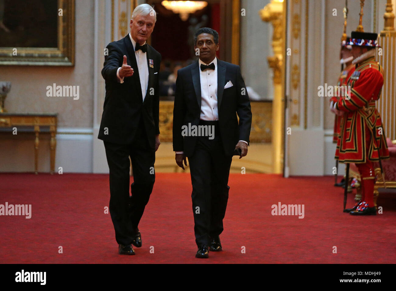 Seychelles President Danny Faure (right) arrives in the East Gallery at Buckingham Palace in London as Queen Elizabeth II hosts a dinner during the Commonwealth Heads of Government Meeting. Stock Photo