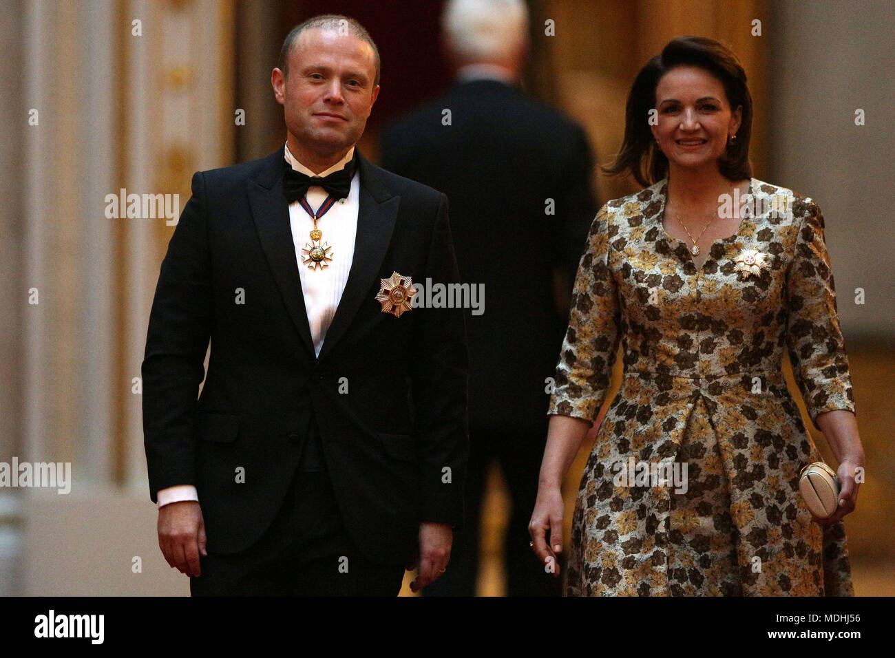 Malta's Prime Minister Joseph Muscat and his wife Michelle arrive in the East Gallery at Buckingham Palace in London as Queen Elizabeth II hosts a dinner during the Commonwealth Heads of Government Meeting. Stock Photo