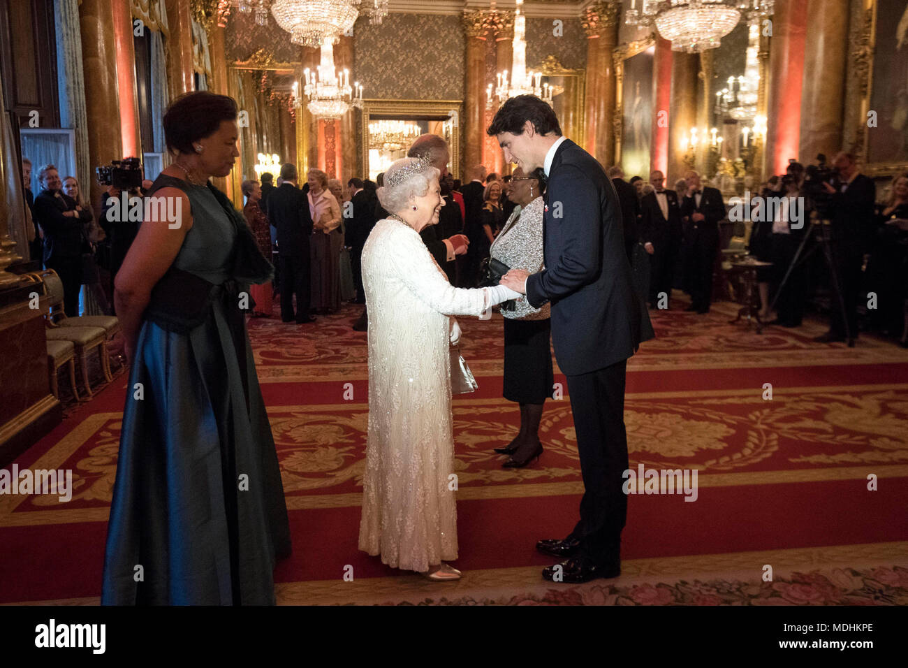 Queen Elizabeth II greets Canada's Prime Minister Justin Trudeau in the Blue Drawing Room at Buckingham Palace in London as she hosts a dinner during the Commonwealth Heads of Government Meeting. Stock Photo
