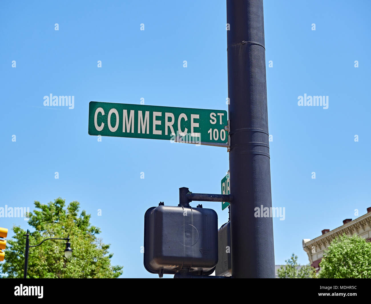 Commerce Street sign overhead on a light pole in downtown Montgomery Alabama, USA indicating the business disctrict. Stock Photo