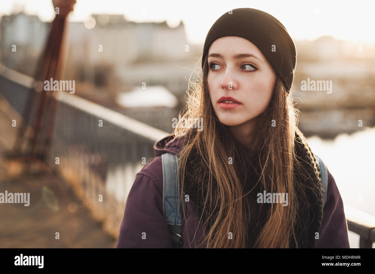 Hipster girl walking on the bridge at sunset Stock Photo