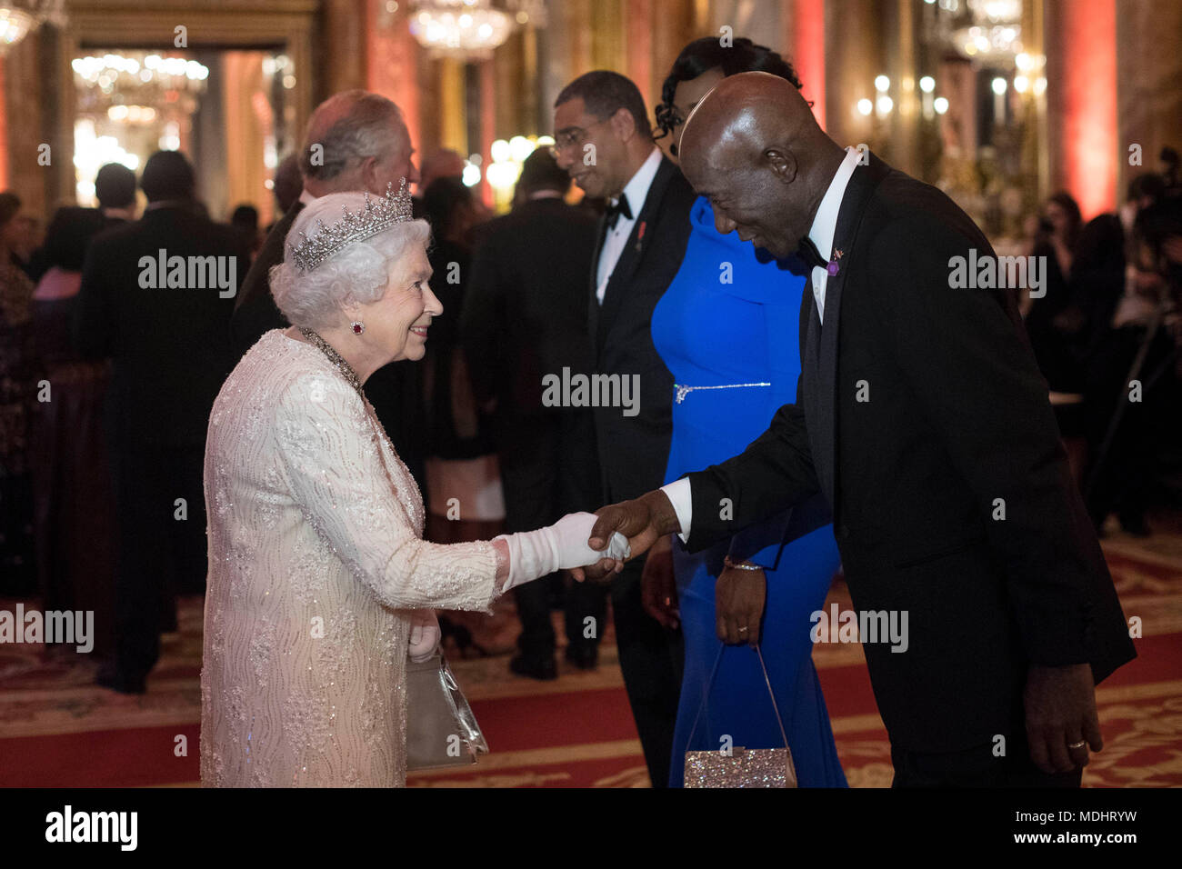 Queen Elizabeth II greets Keith Rowley, Prime Minister of Trindad and Tobago, in the Blue Drawing Room at Buckingham Palace in London as she hosts a dinner during the Commonwealth Heads of Government Meeting. Stock Photo
