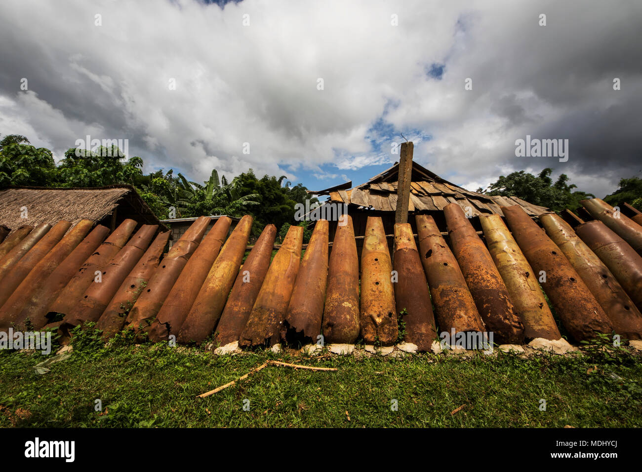 Wall made from bomb casings in Na Kam Peng, also called Bomb Village; Na Kam Peng, Xiangkhouang, Laos Stock Photo