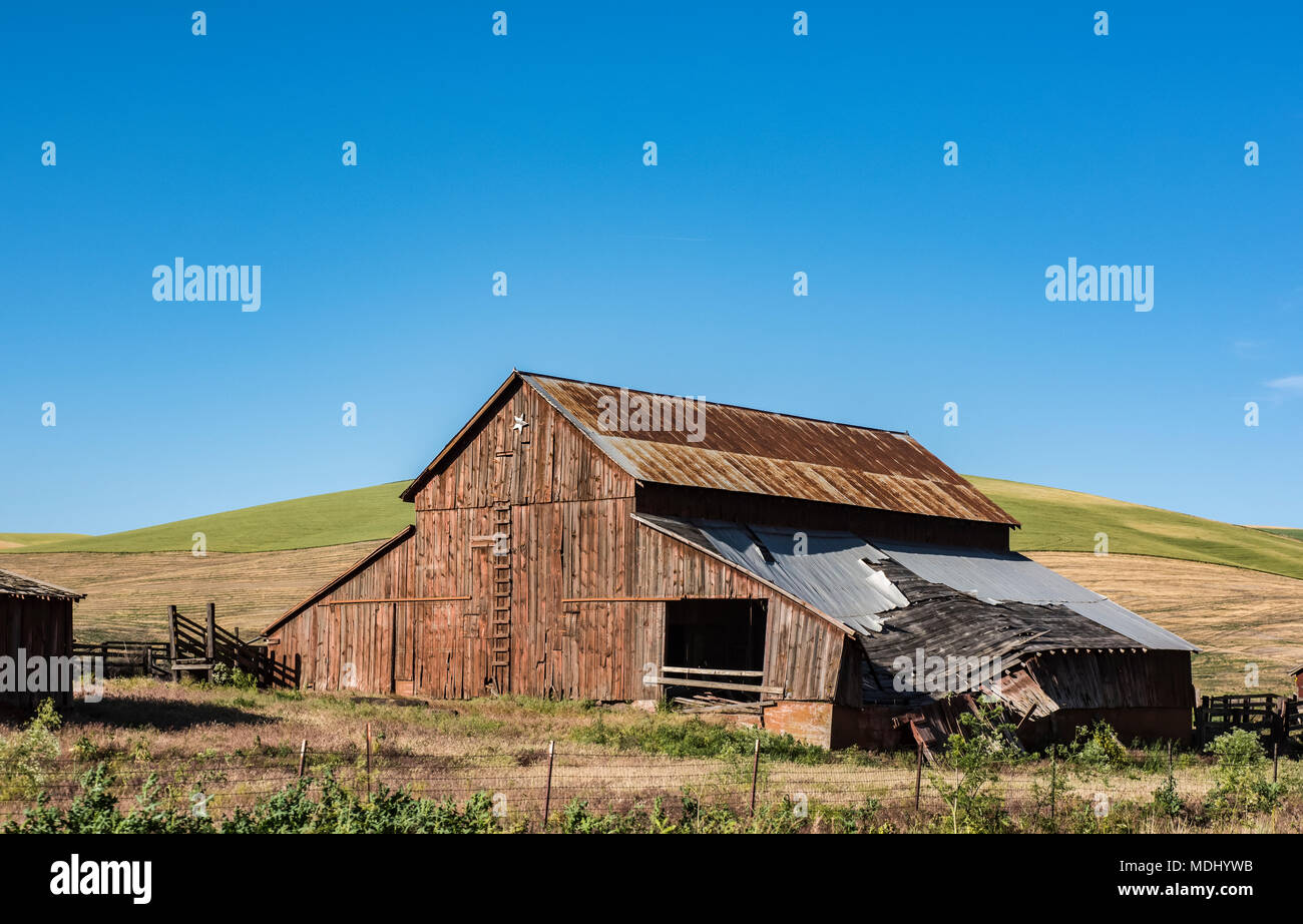 An old, decrepit barn with a failing roof, Eastern Washington; Dayton, Washington, United States of America Stock Photo