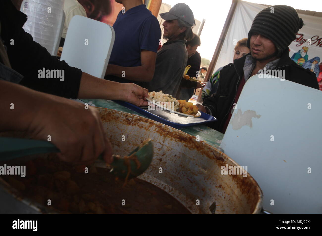 Migrantes Hondureños durante su paso por Hermosillo con rumbo al Norte se reúnen en un comedor a punto de medio dÃa. .staff /nortephoto.com,CREDI Stock Photo