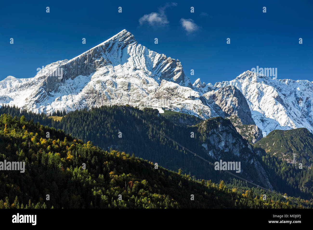 Snow-covered rugged mountain range with blue sky; Garmisch-Partenkirchen, Bavaria, Germany Stock Photo