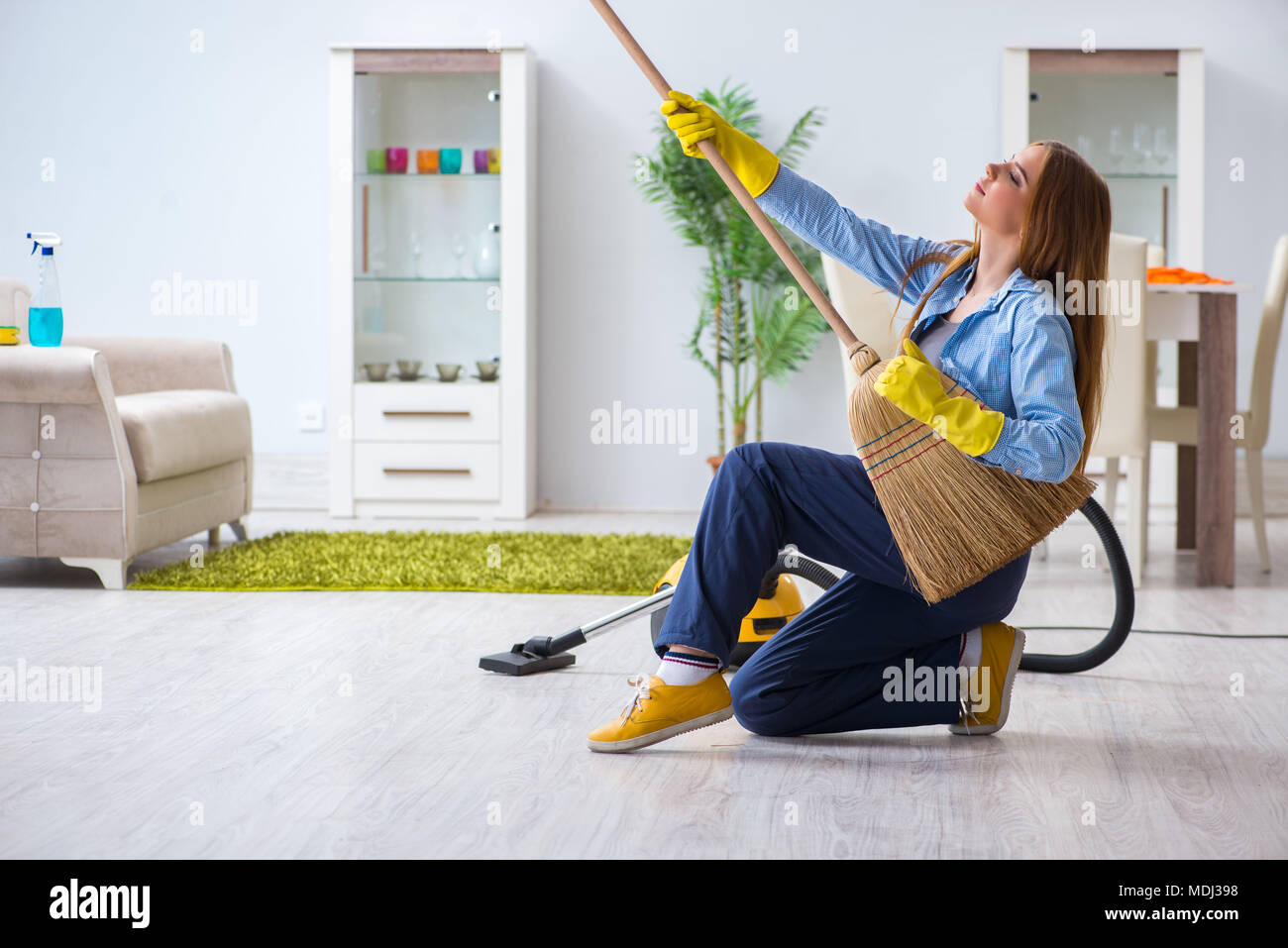 Young woman cleaning floor at home doing chores Stock Photo Alamy