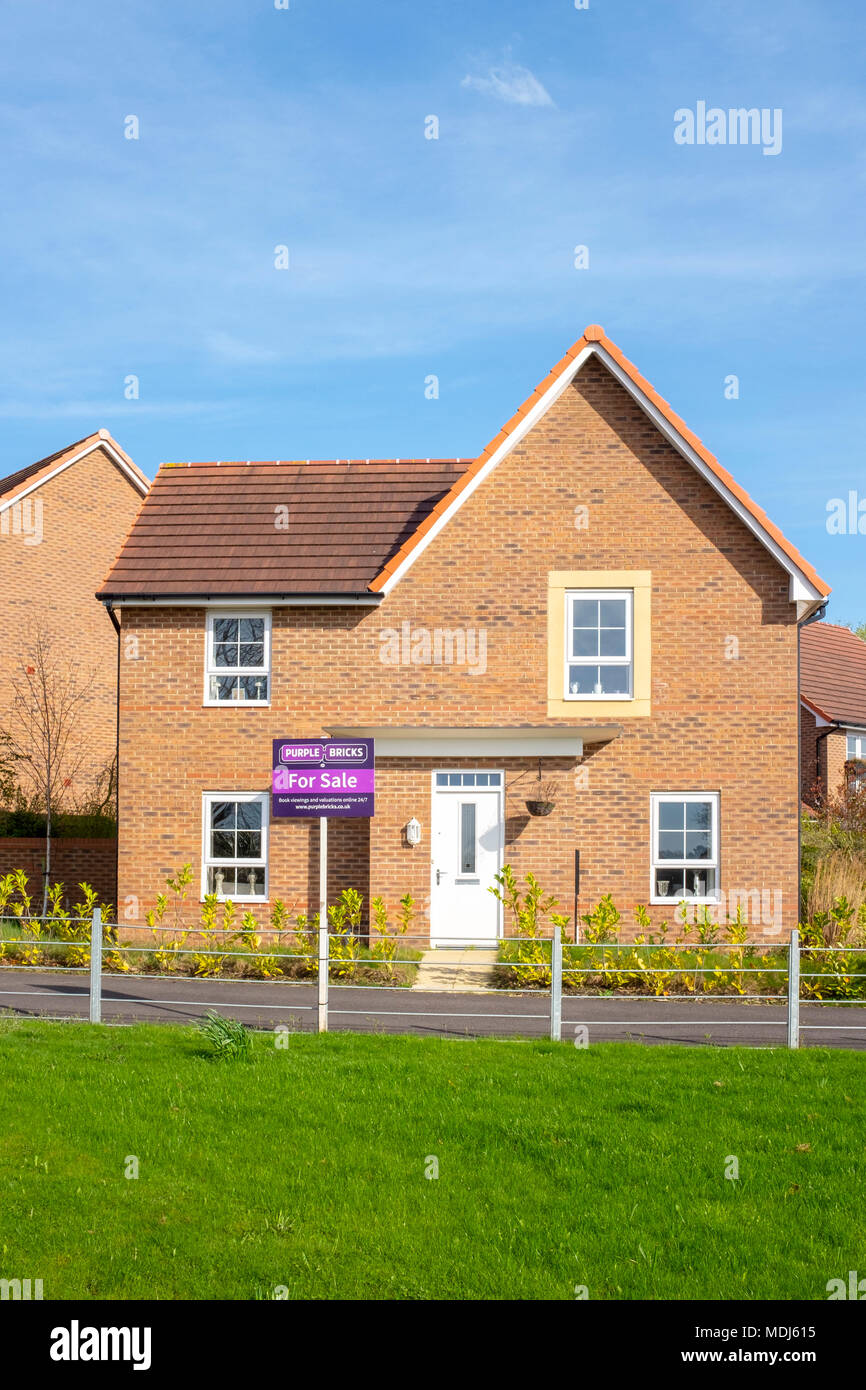 Purple bricks house for sale sign in front of a new house UK Stock Photo Alamy