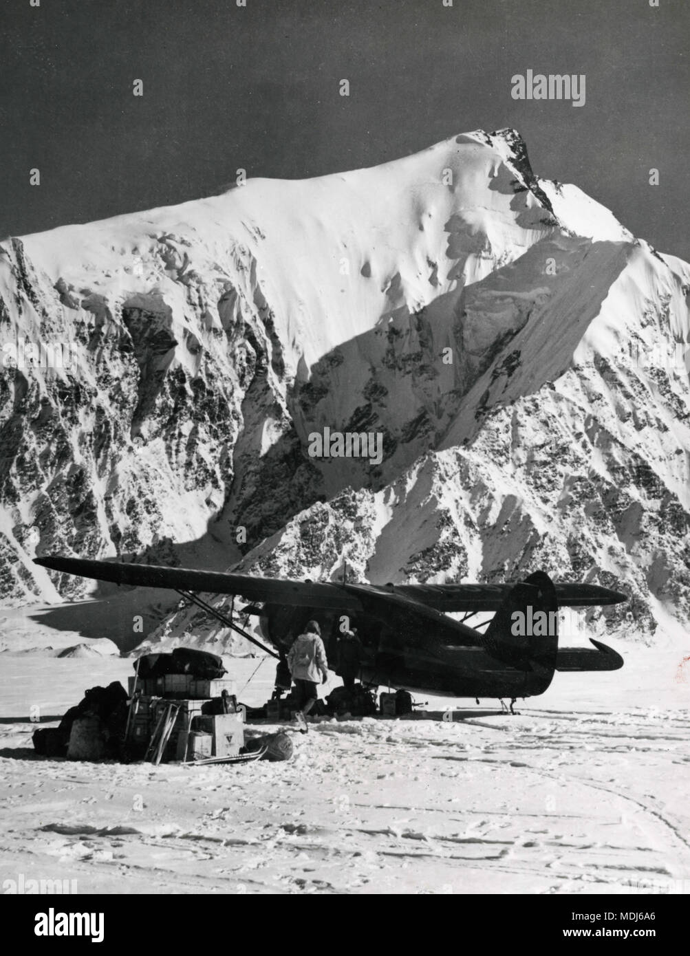 Small airplane landed in Muldrow Glacier, McKinley mountain, Alaska, USA 1950s Stock Photo