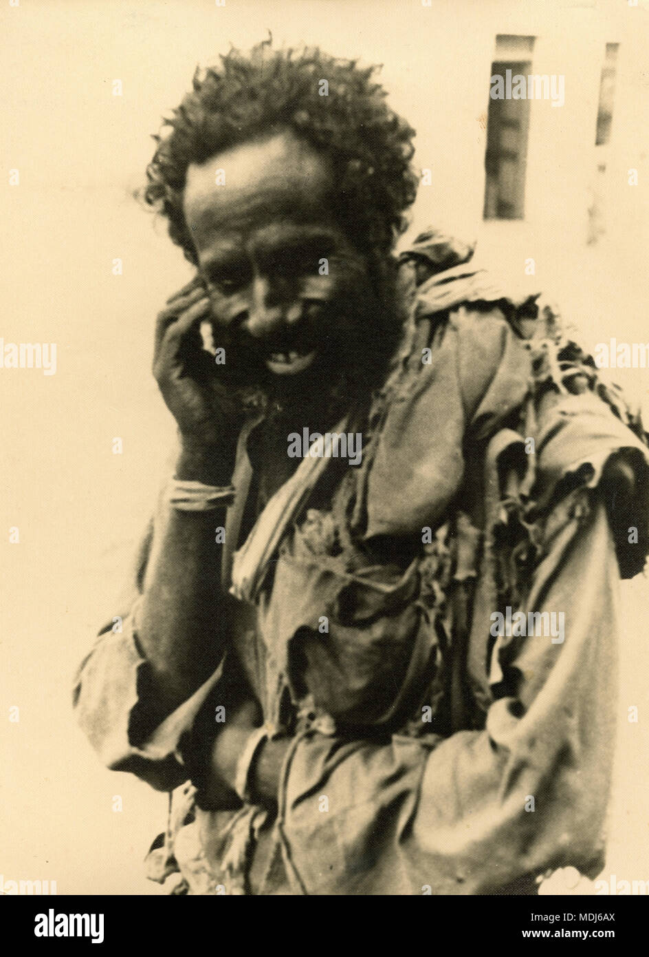 North African man in rags seems talking to the cellphone, 1930s Stock Photo