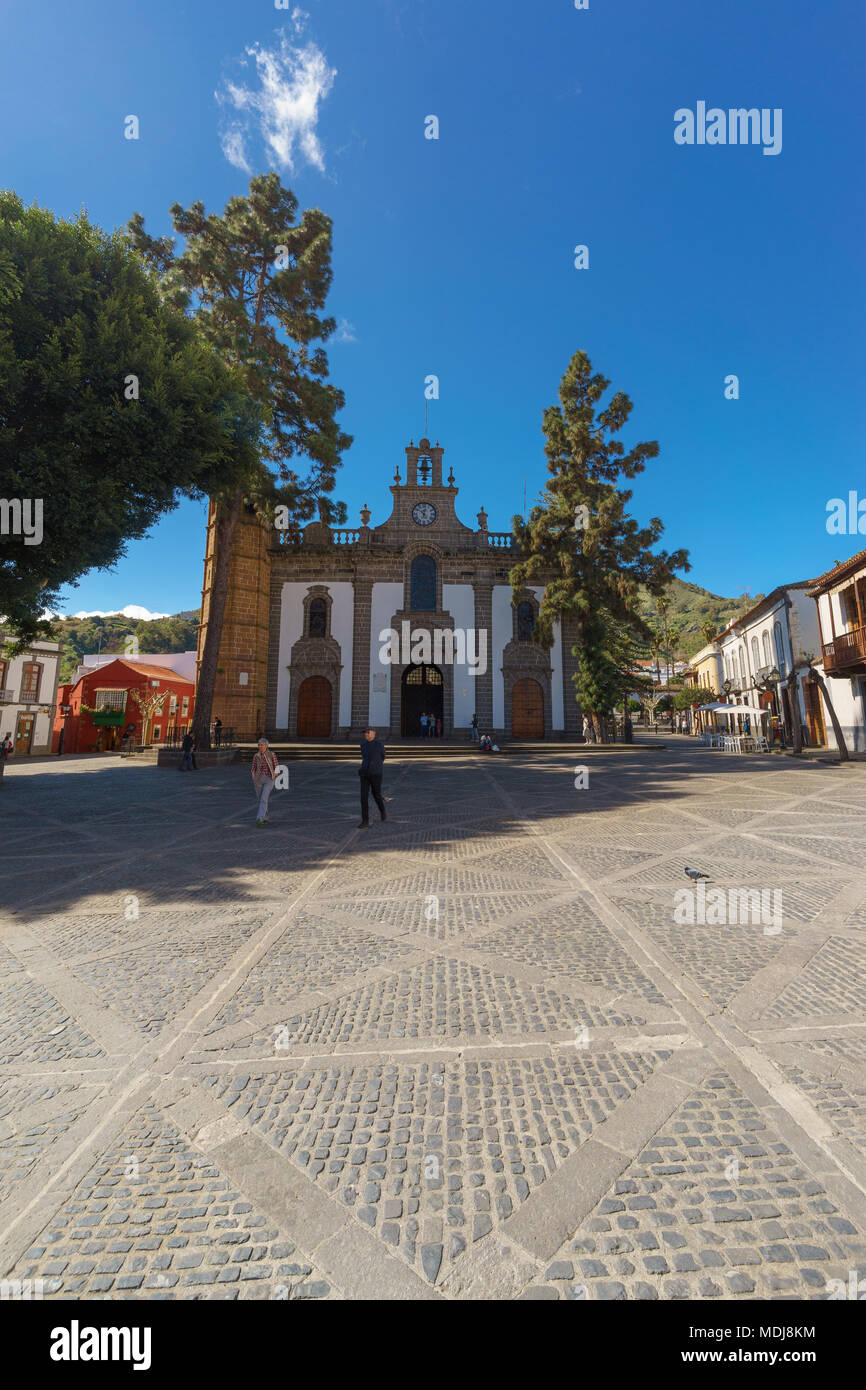 Teror, Spain - February 27, 2018: Tourists enjoying sunny day on town square in front of Basilica de Nuestra Senora del Pino. Stock Photo