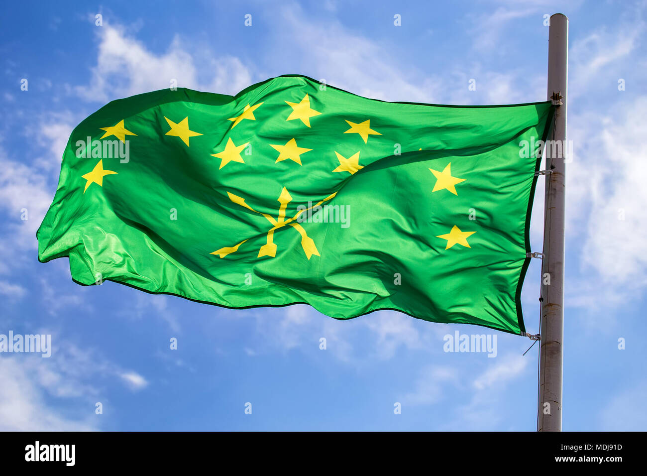 Adygian flag on sky and cloud background Stock Photo