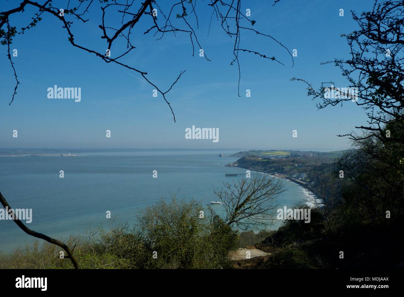 view across Totland Bay, Isle of Wight, United Kingdom towards the solent with Hurst Spit and castle on the mainland and Fort Albert on the island Stock Photo